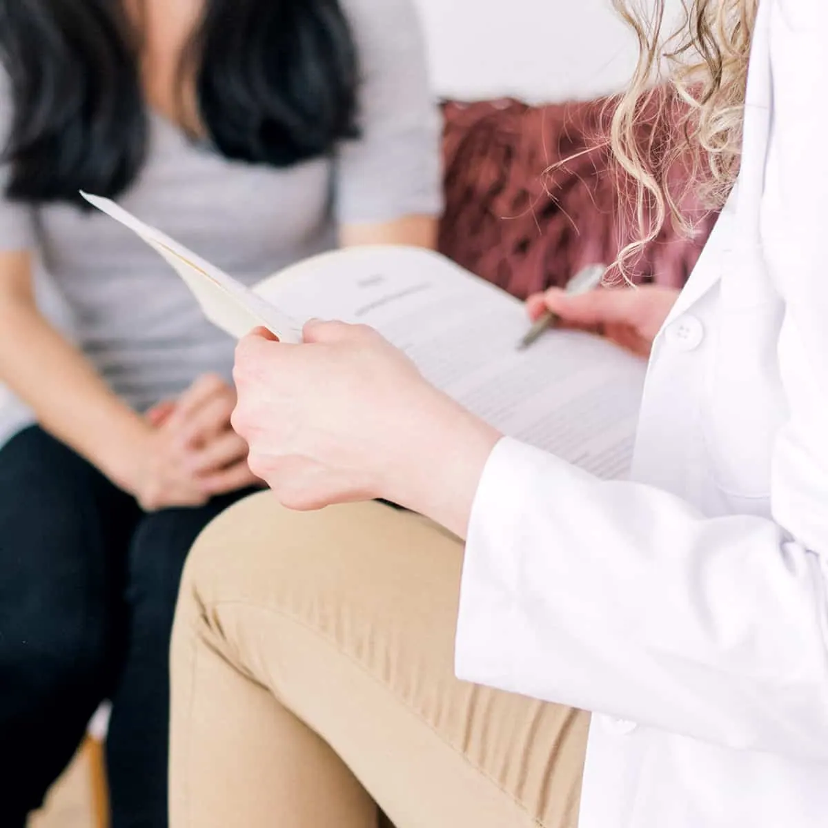 Healthcare professional reviewing documents with a patient during a consultation