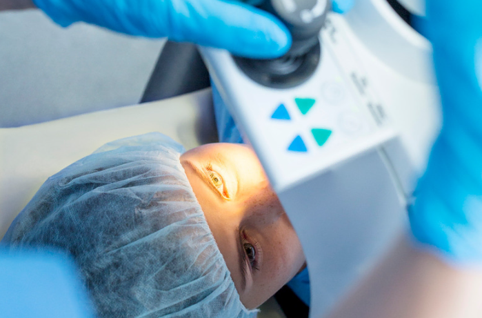 Close-up of a person's eye during an examination with medical equipment.