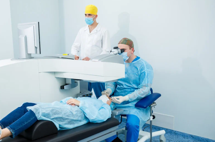 Two medical professionals performing an eye examination on a patient.
